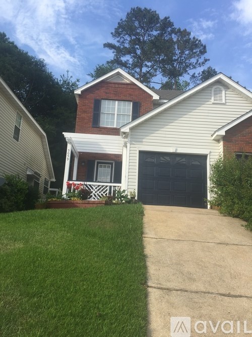 A house with a garage and a driveway in front.