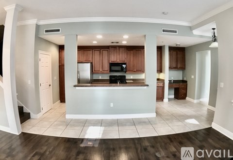 A kitchen with wooden cabinets and a white fridge.