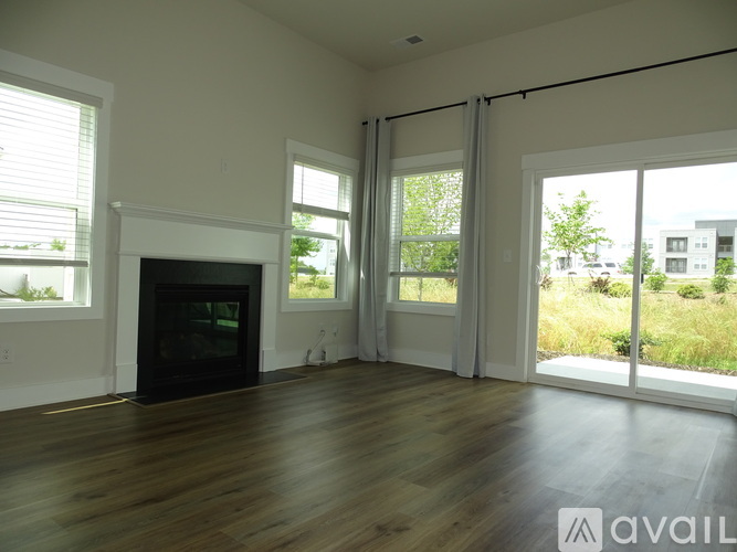 A living room with a fireplace and sliding glass doors.