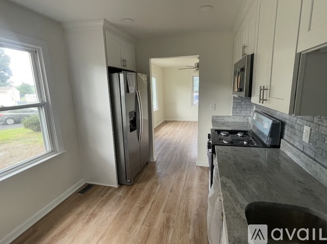 A kitchen with a refrigerator, stove, and oven.