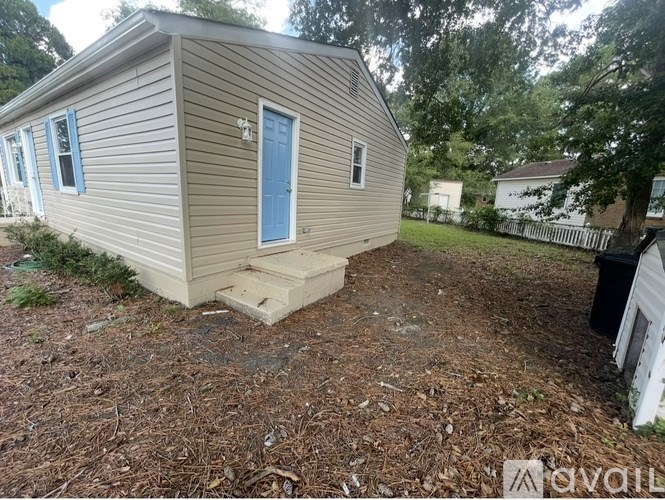 A room with wooden flooring and a ceiling fan.