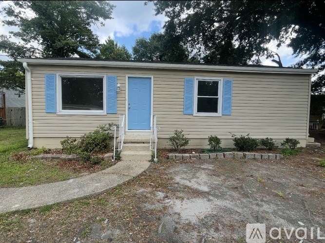 A small house with a blue door and window shutters.