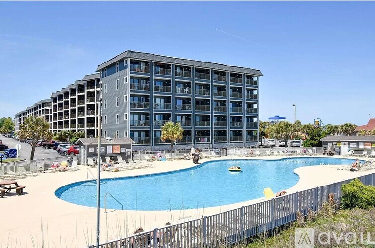 A large building with a pool in front of it.