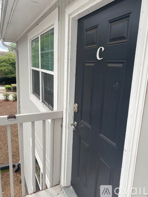 A black door with a white frame and a white window with a white frame.