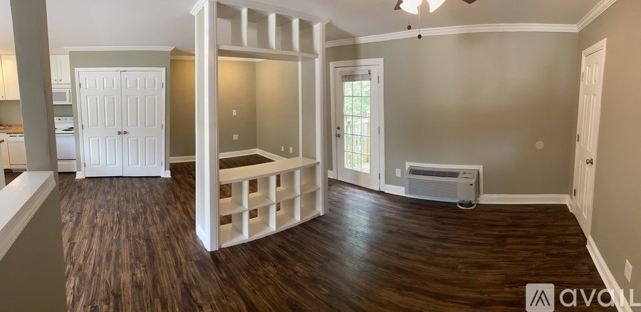 A room with wooden floors and a white door.