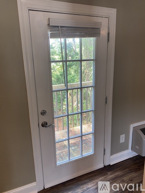 A white door with a window and a handle.