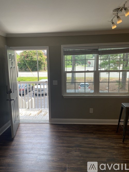 A room with a view of a parking lot through a window.