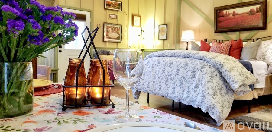 A bedroom with a bed covered in a blue and white patterned blanket.