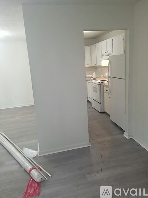 A kitchen with white cabinets and appliances is shown.