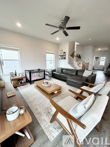 A living room with a black couch and a wooden coffee table.