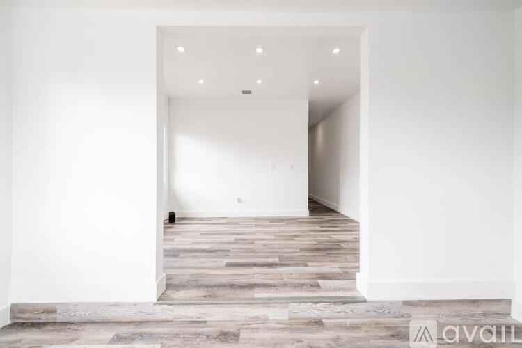 A room with a wooden floor and white walls.