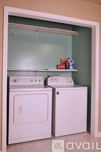 A small laundry room with a washer and dryer.