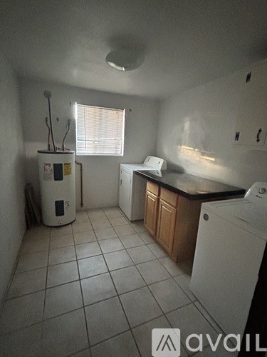 A small laundry room with a washer and dryer.