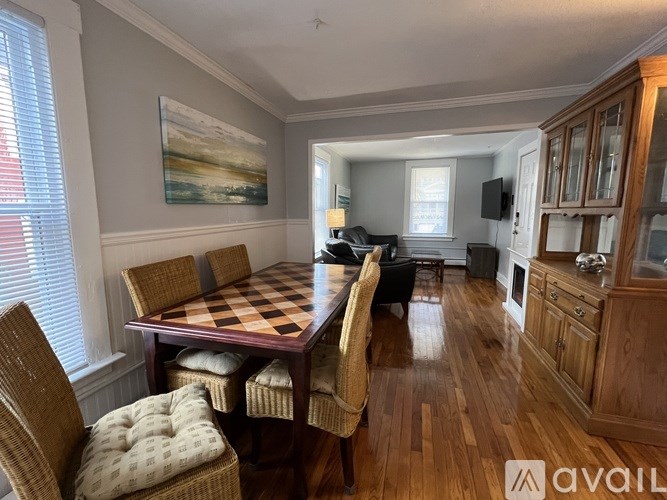 A dining room with a checkered table and chairs.