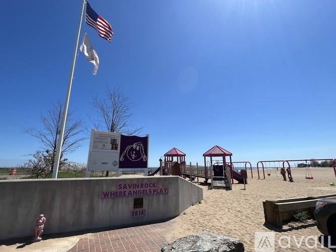 A playground with a sign that reads "Savin Rock Where Angels Play 2014".