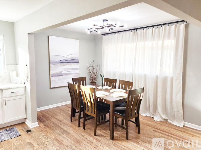 A dining room with a table set for six.