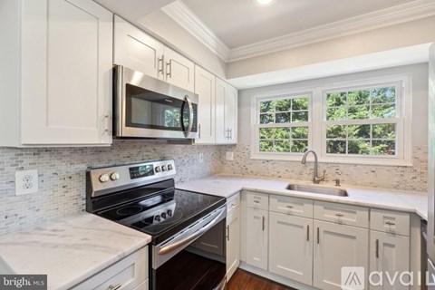 A kitchen with a stove top oven and microwave.