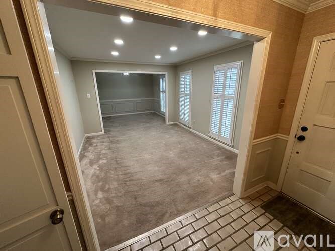 A room with a tiled floor and a door on the left.