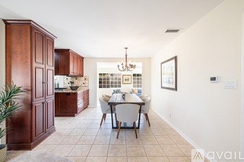 A dining room with a table set for four.