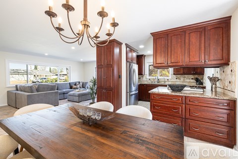 A modern kitchen with wooden cabinets and a large island.