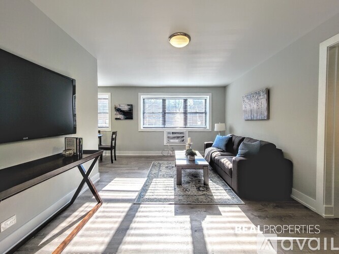A living room with a flat screen TV and a couch.