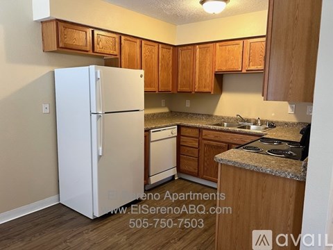 A kitchen with wooden cabinets and a white refrigerator.