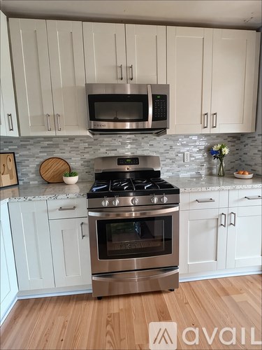 A kitchen with a stove top oven and a microwave above it.