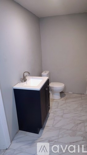A bathroom with a toilet and sink.
