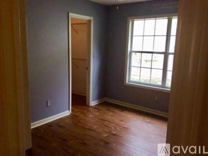 A room with a wooden floor and a window.