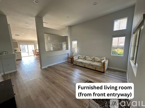 A living room with a couch and a mirror on the wall.
