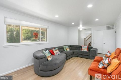 A living room with a grey sofa and orange couch.