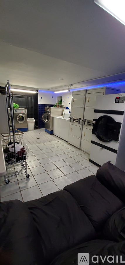 A kitchen with white cabinets and a tiled floor.