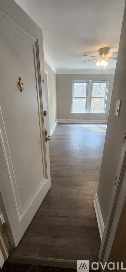 A kitchen with white cabinets and a tiled floor.