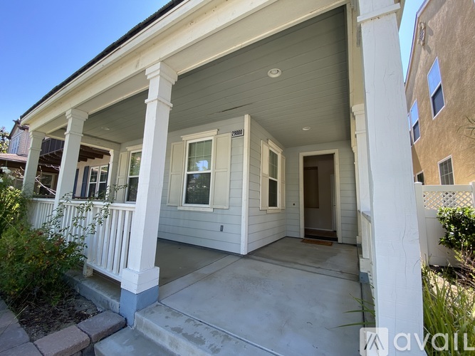 A small house with a porch and a front door.