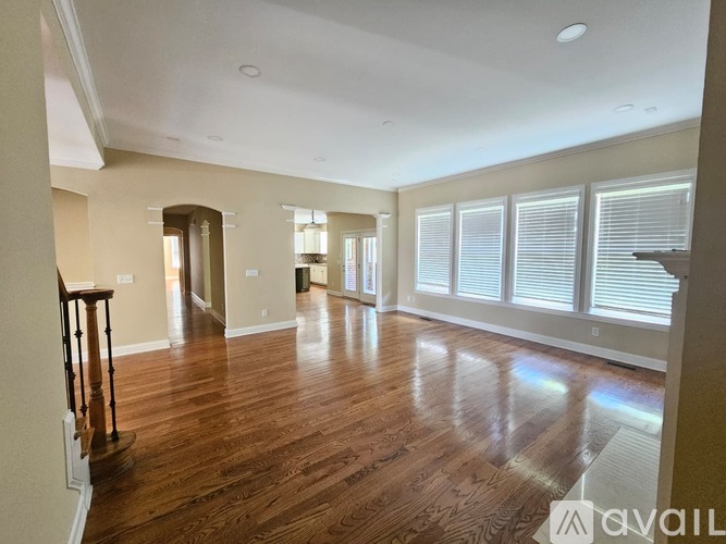 A kitchen with a granite countertop and wooden floors.
