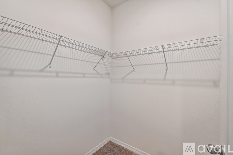 A wire shelf in a white room.