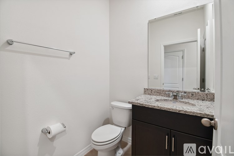 A white toilet sits next to a sink in a bathroom.