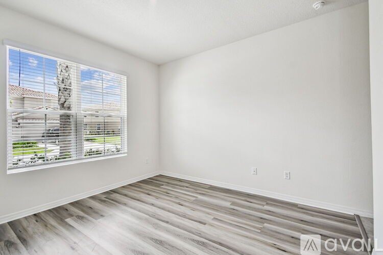 A room with carpeted floor and white walls.