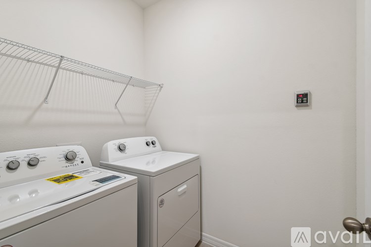 A small laundry room with a washer and dryer.