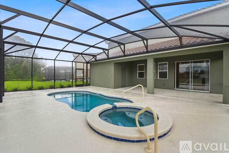 A kitchen with granite countertops and dark brown cabinets.