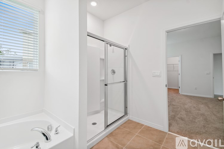 A bathroom with a tub and a walk-in shower.