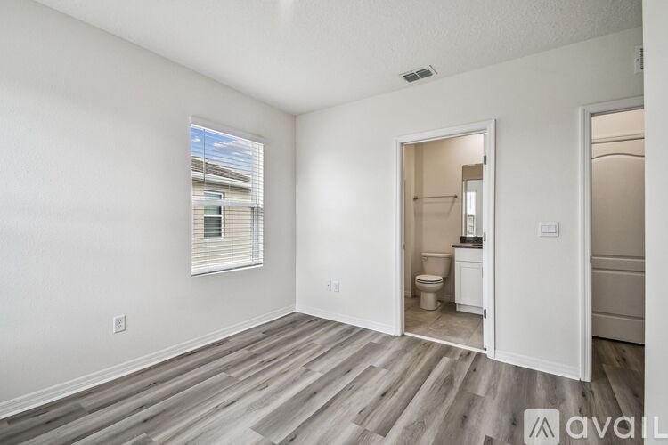 A bathroom with a granite countertop and a large mirror.
