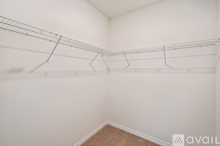 A white wall with a metal rack on it.