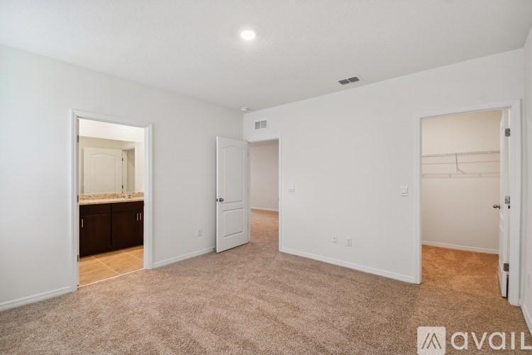 A large, empty room with carpeted flooring and white walls.