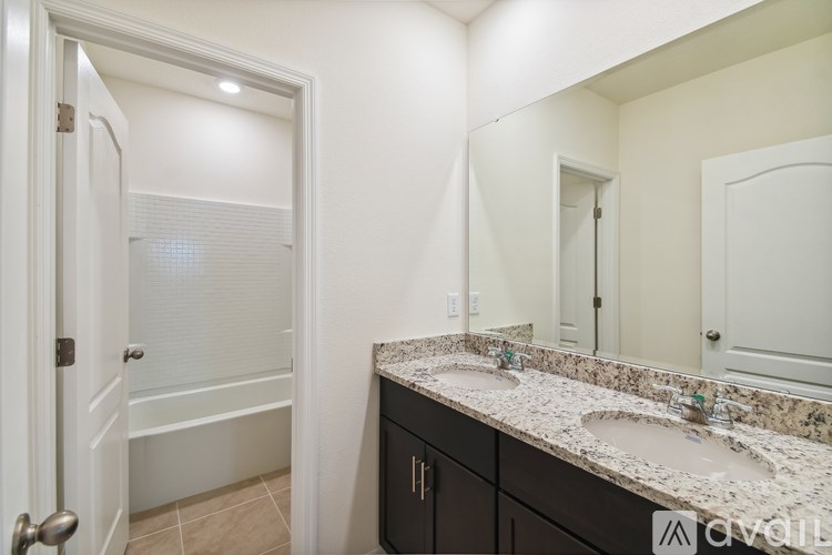 A bathroom with a marble countertop and a white door.