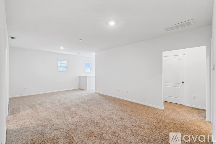 A room with white walls and carpeted floor is available for rent.
