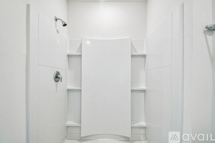 A room with two doors and a carpeted floor.