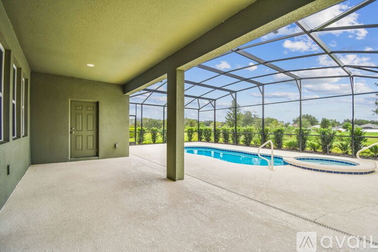 A pool under a black metal roof.