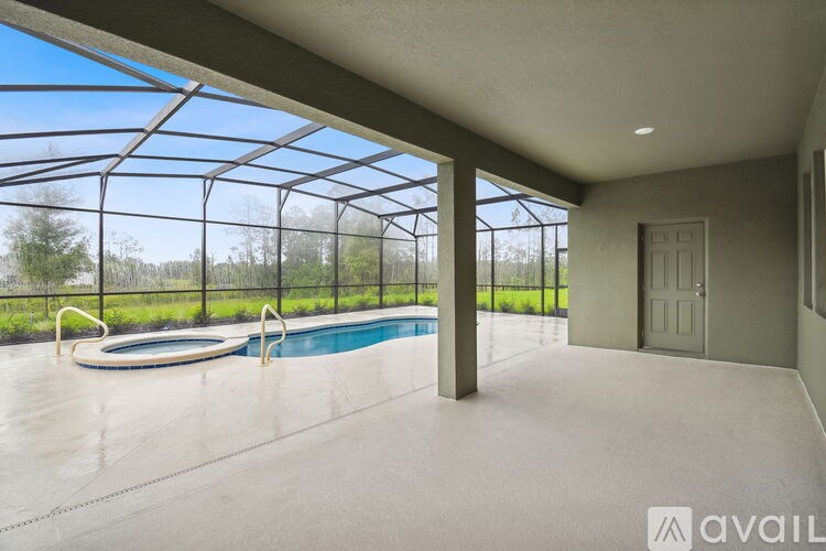 A pool inside a house with a glass wall.