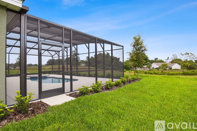 A glass-walled building with a pool in the foreground.
